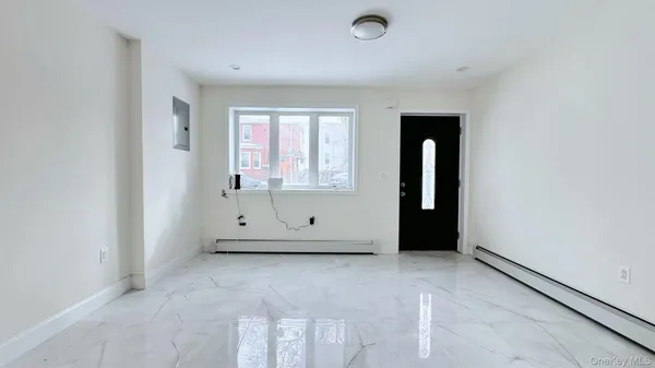 an empty room with cabinet and mirrors