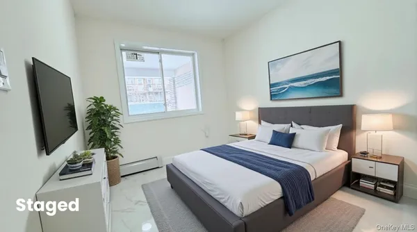 a bedroom with a bed and a flat screen tv