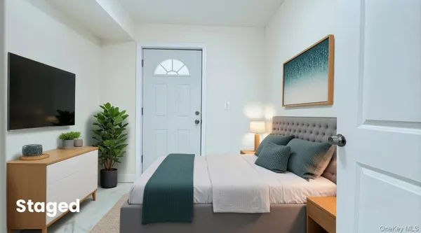 a bedroom with a bed and a flat screen tv