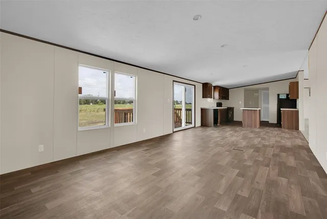 a view of empty room with furniture and window