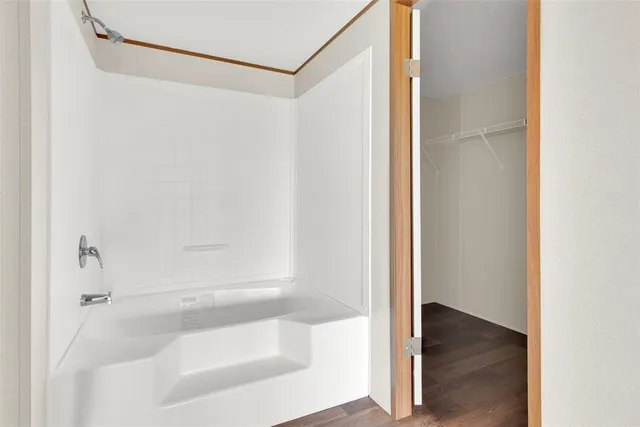 a bathroom with a glass shower door