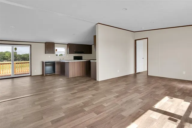 a view of a kitchen with a sink a refrigerator and window