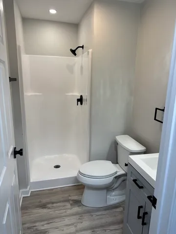 a white toilet sitting next to a bathroom sink