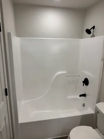 a bathroom with a bathtub and a toilet