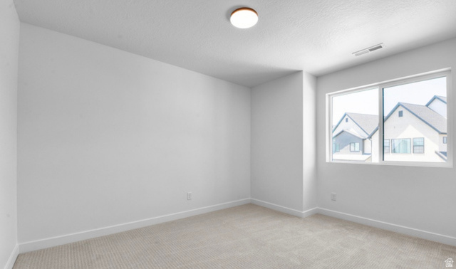 2415 North Ribe Lane Lehi, UT 84048 - Photo 12 of 17 Spare room with light colored carpet and a textured ceiling
