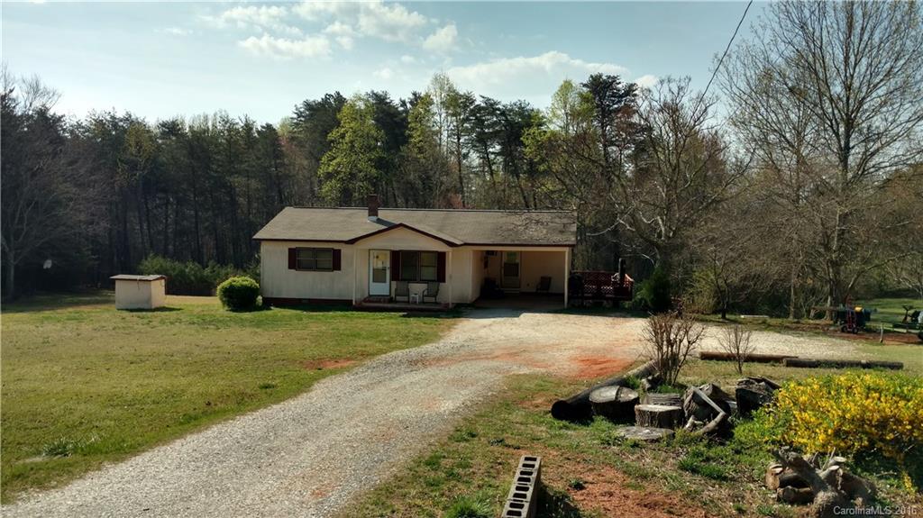 2960 Peniel Road Columbus, NC 28722 - Photo 2 of 4 a front view of a house with a yard garage and trees