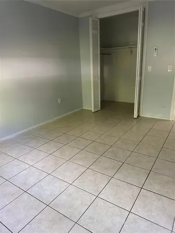 a front view of a house with a garden and plants