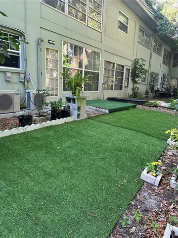 a view of a patio with dining table and chairs with plants