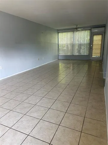 a view of an empty room and a window
