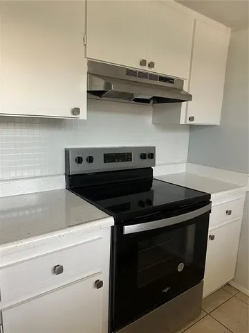 a close view of stove top oven and cabinets