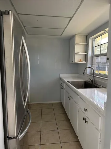 a kitchen with a sink a washer and dryer next to a window