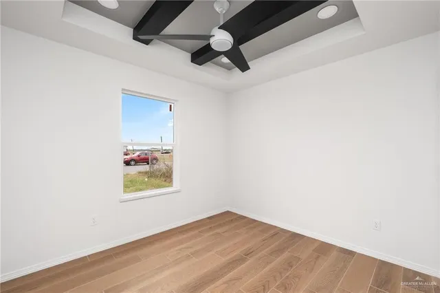 an empty room with wooden floor