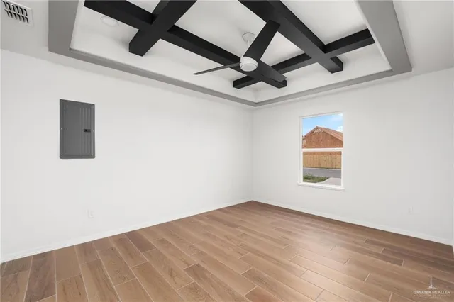an empty room with a window and ceiling fan