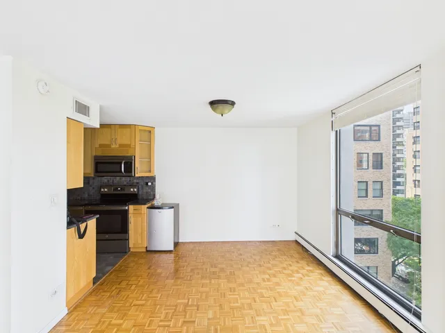 a kitchen with granite countertop a stove and a sink
