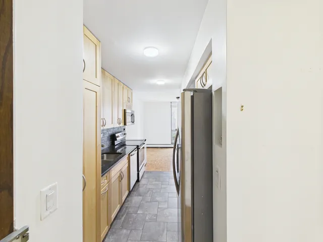 a kitchen with a refrigerator and a sink