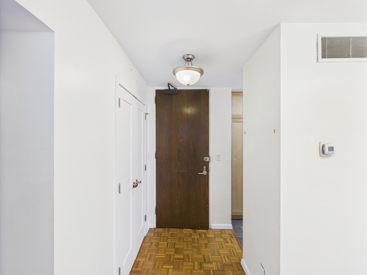 1310 North Ritchie Court, Unit 7D Chicago, IL 60610 - Photo 23 of 38 a view of a hallway with wooden floor and closet