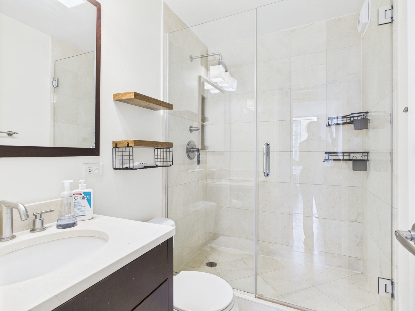 1310 North Ritchie Court, Unit 7D Chicago, IL 60610 - Photo 28 of 38 a bathroom with a granite countertop sink toilet a mirror and shower