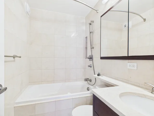 a bathroom with a sink toilet tub and shower