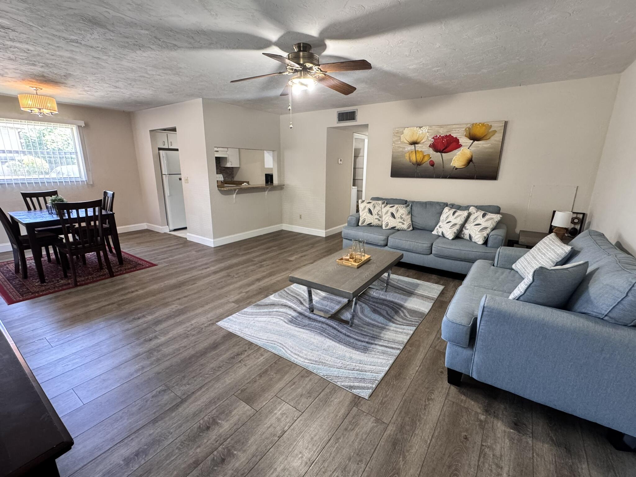 a living room with furniture and wooden floor