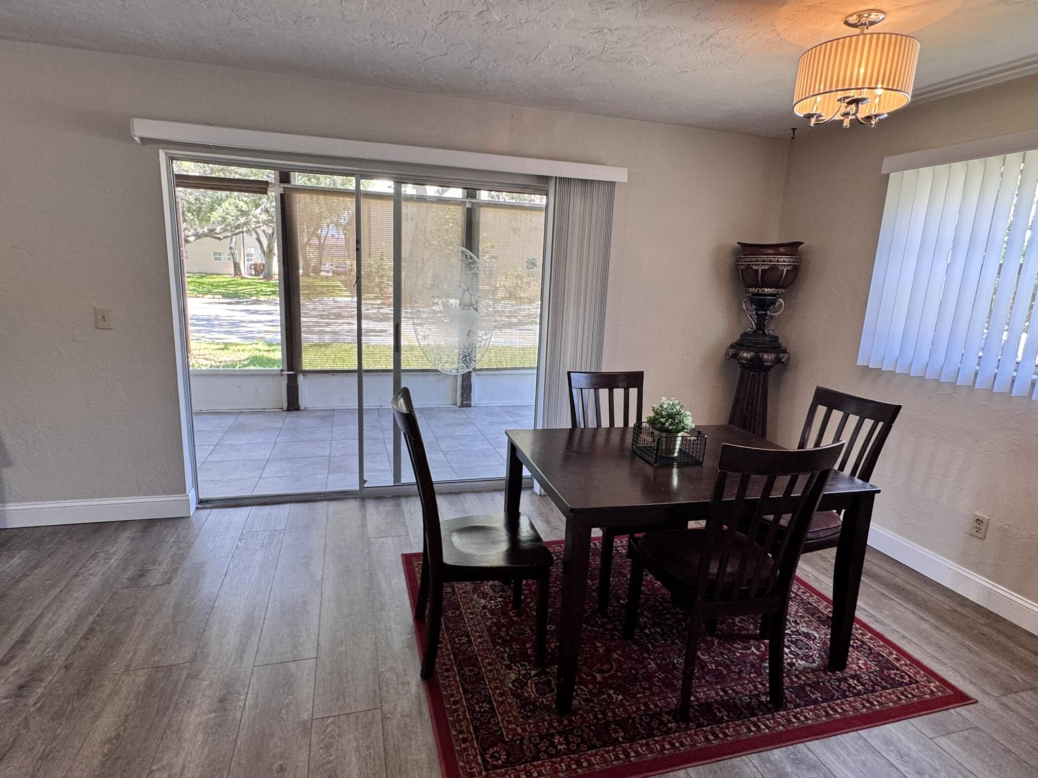 3124 Highway 441, Unit J1 Okeechobee, FL 34974 - Photo 26 of 40 a view of a dining room with furniture window and wooden floor