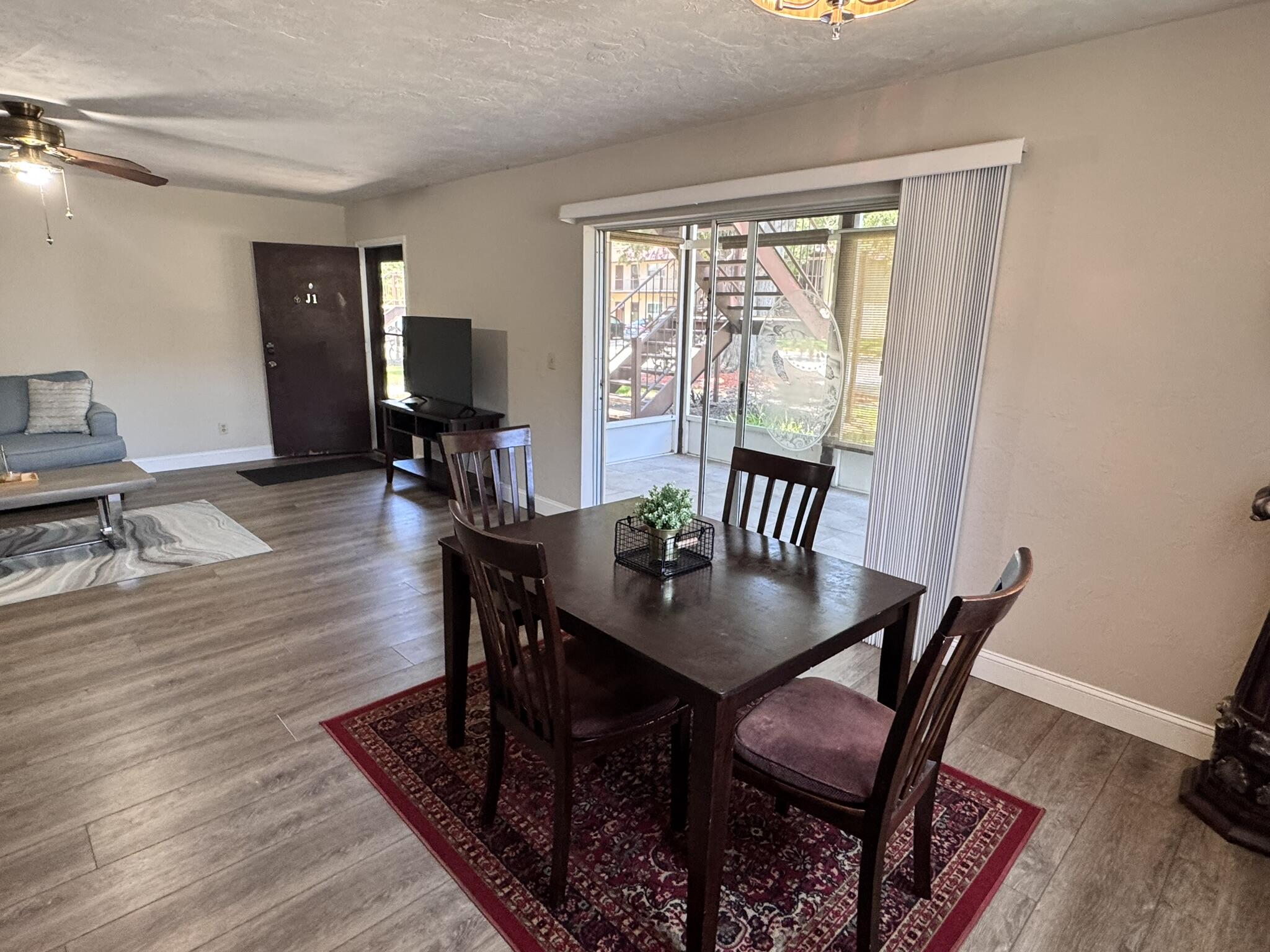 3124 Highway 441, Unit J1 Okeechobee, FL 34974 - Photo 27 of 40 a view of a dining room with furniture window and wooden floor