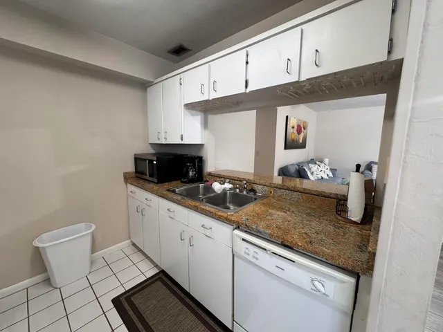 a kitchen with sink and cabinets