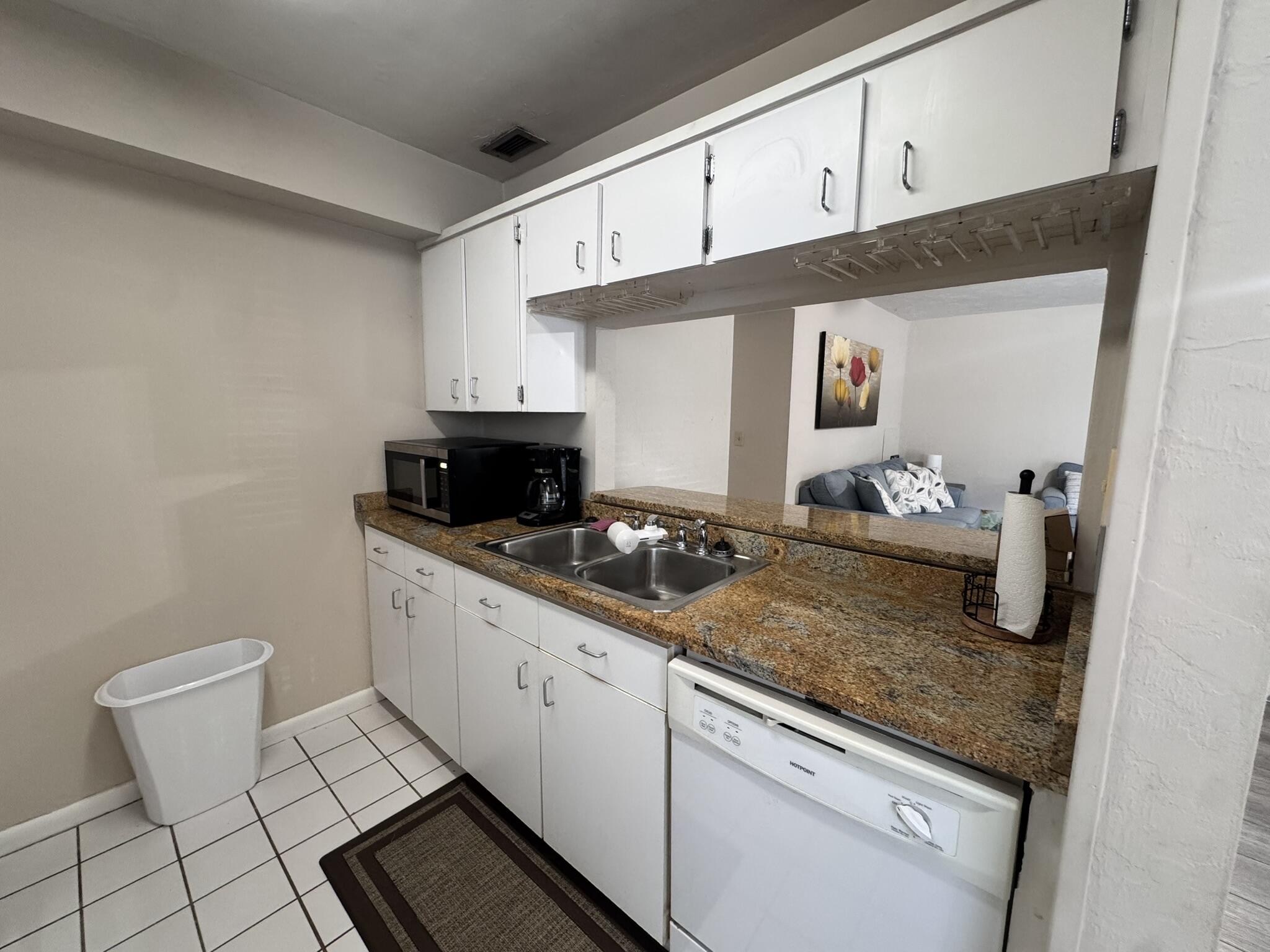 3124 Highway 441, Unit J1 Okeechobee, FL 34974 - Photo 8 of 40 a kitchen with sink and cabinets