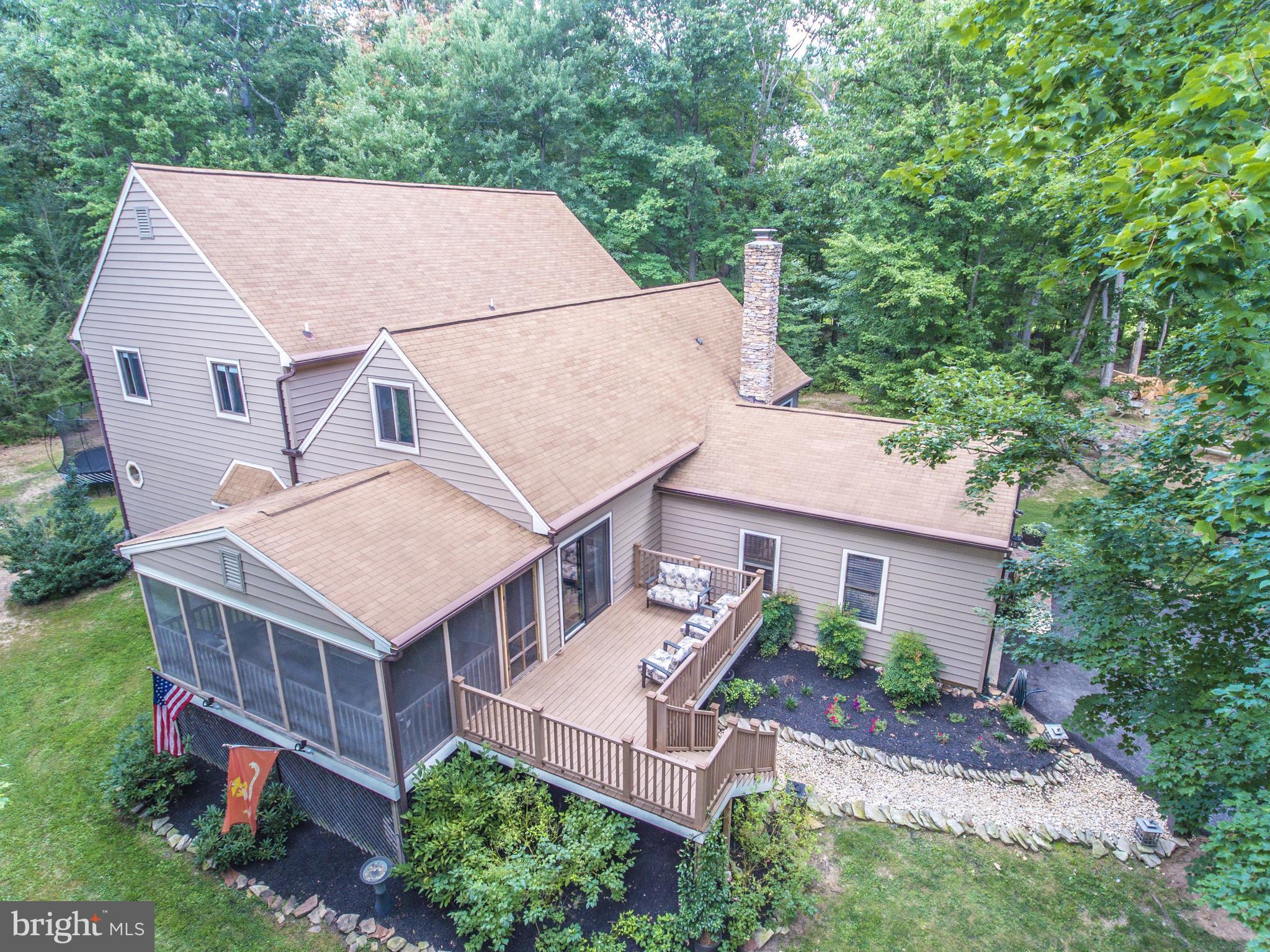 6123 Davis Road Woodbine, MD 21797 - Photo 1 of 30 an aerial view of a house with a yard and potted plants