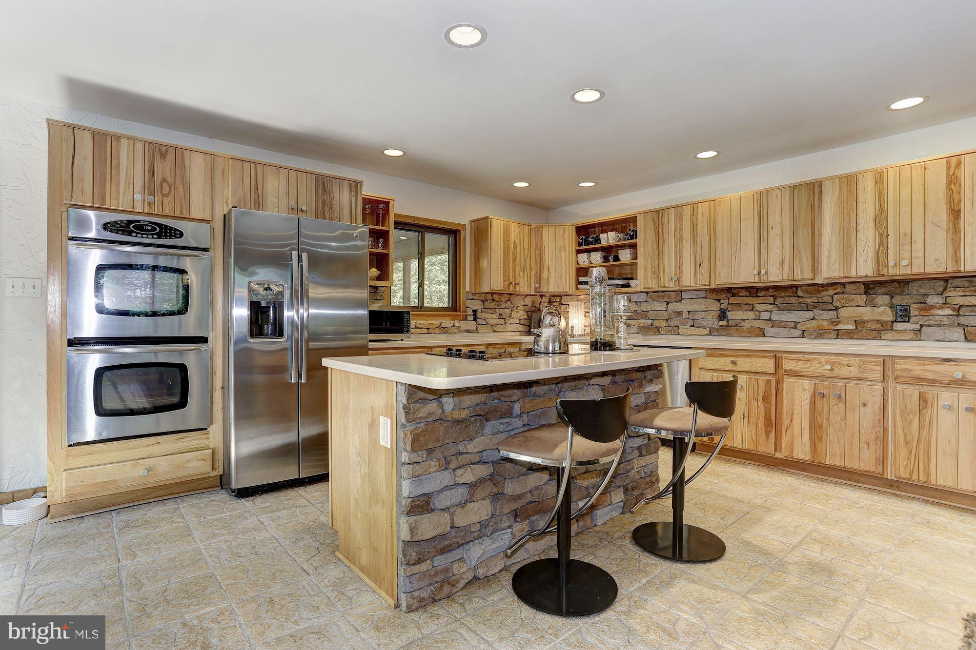 6123 Davis Road Woodbine, MD 21797 - Photo 11 of 30 a kitchen with kitchen island granite countertop stainless steel appliances a stove a sink a oven a counter top space and cabinets