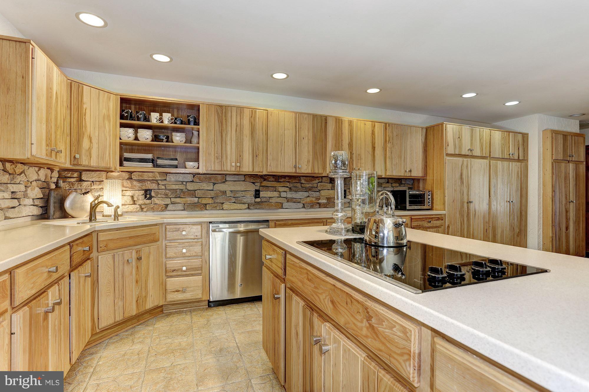 6123 Davis Road Woodbine, MD 21797 - Photo 12 of 30 a kitchen with kitchen island granite countertop a sink stainless steel appliances and cabinets