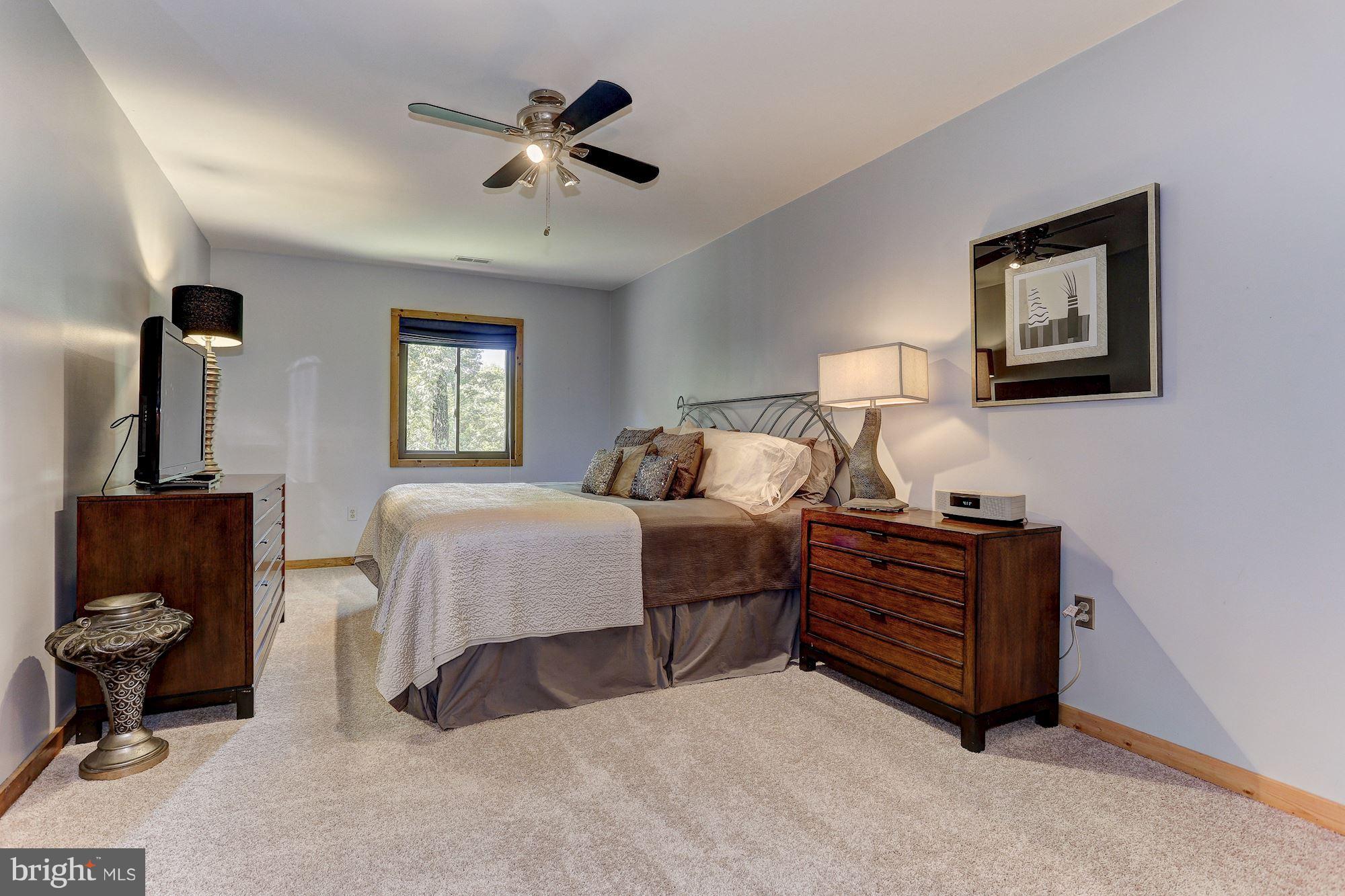 6123 Davis Road Woodbine, MD 21797 - Photo 23 of 30 a bedroom with bed cabinet and window