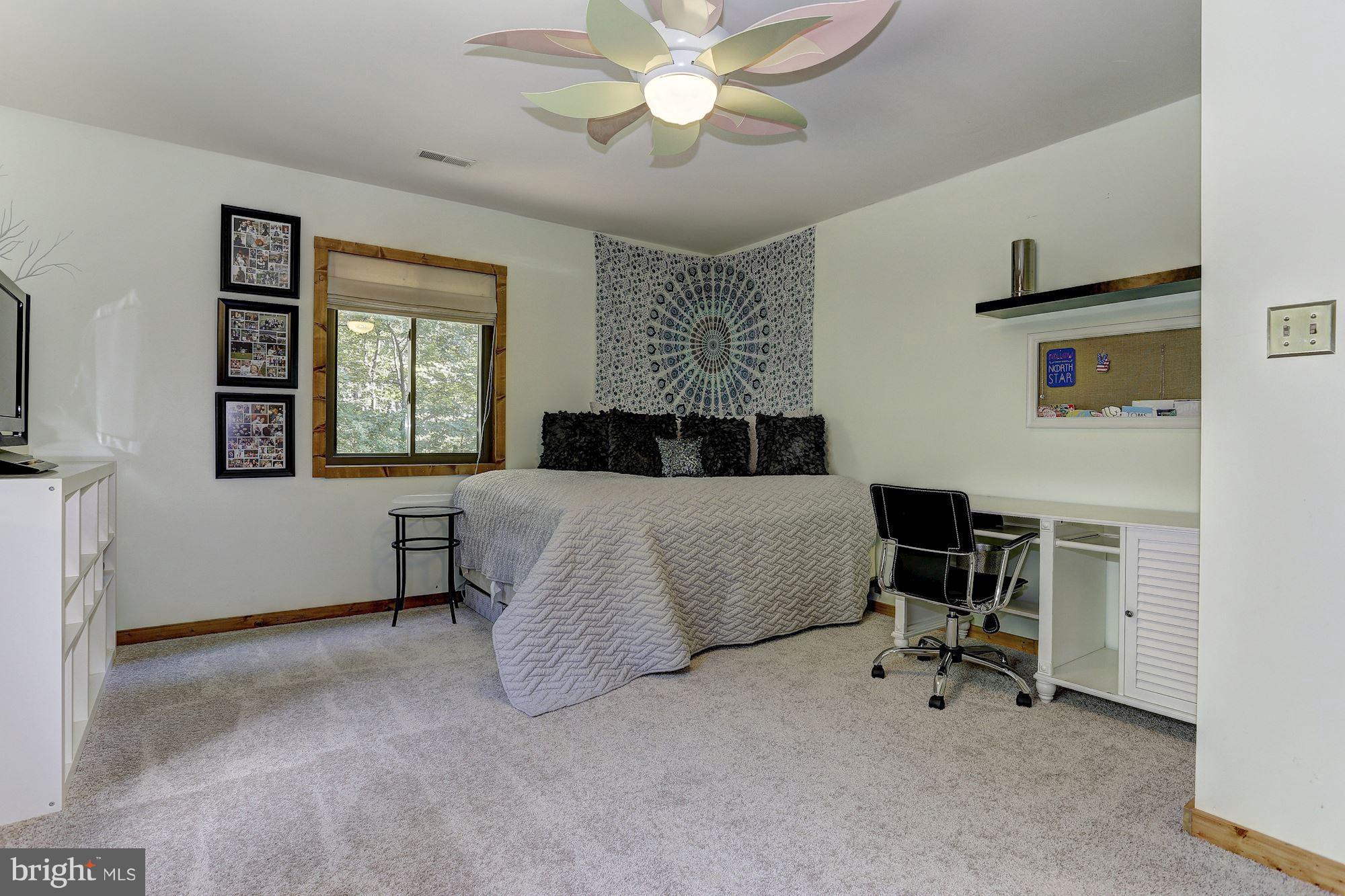 6123 Davis Road Woodbine, MD 21797 - Photo 25 of 30 a bedroom with a bed and a chandelier