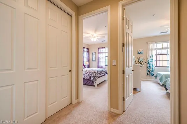 a view of a hallway with bathroom and wooden floor