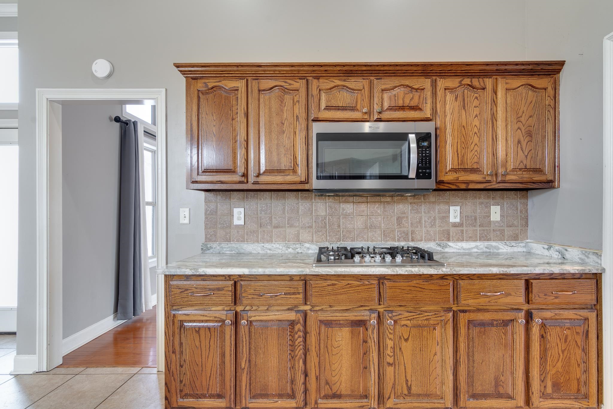 43 Tipton Rdg Cove Munford, TN 38058 - Photo 11 of 30 a kitchen with granite countertop white cabinets stainless steel appliances and a sink