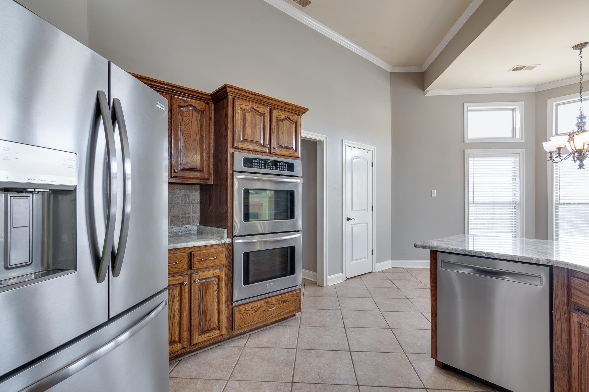 43 Tipton Rdg Cove Munford, TN 38058 - Photo 12 of 30 a kitchen with stainless steel appliances granite countertop a refrigerator and a sink