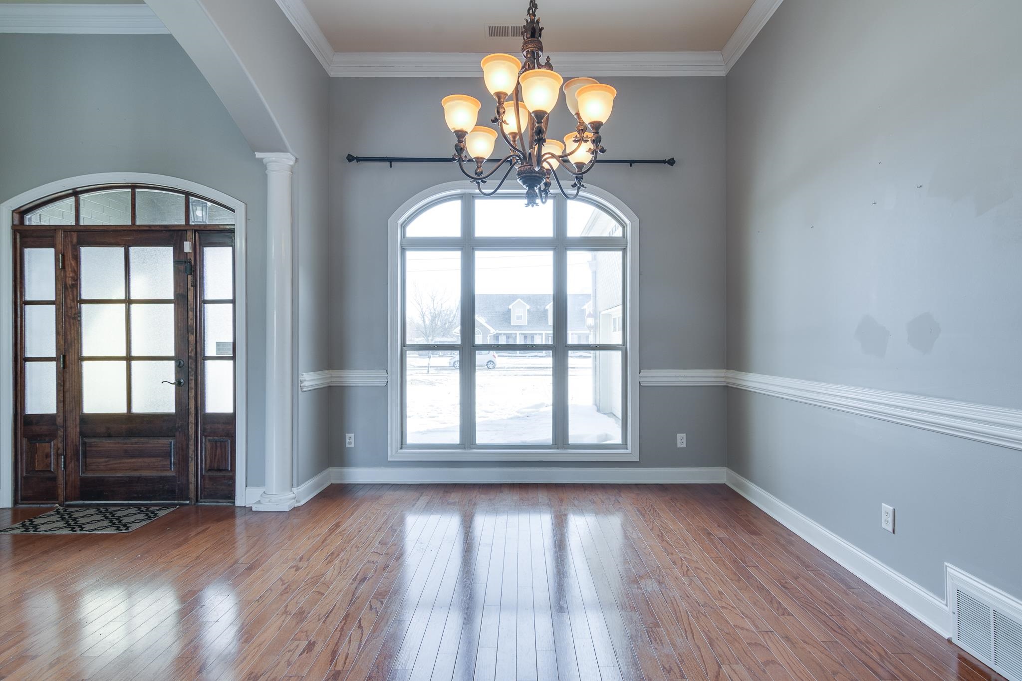 43 Tipton Rdg Cove Munford, TN 38058 - Photo 2 of 30 Foyer entrance with arched walkways, a chandelier, wood-type flooring, crown molding, and decorative columns