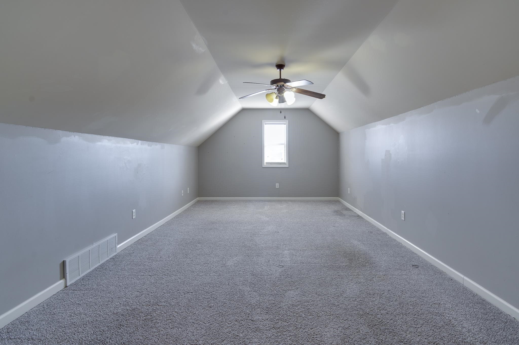 43 Tipton Rdg Cove Munford, TN 38058 - Photo 24 of 30 an empty room with a window and a ceiling fan