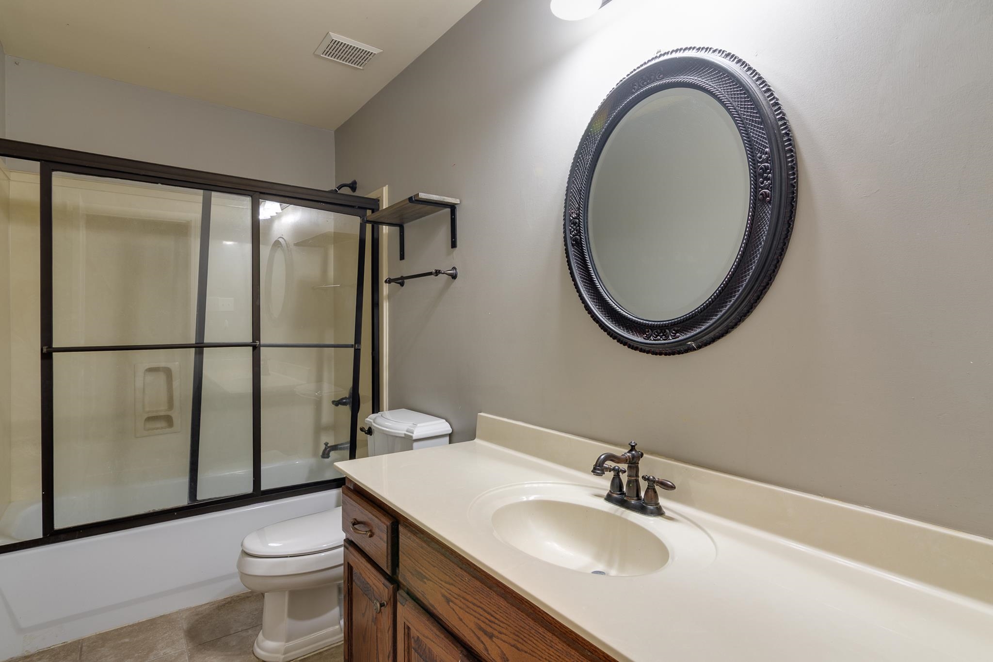 43 Tipton Rdg Cove Munford, TN 38058 - Photo 26 of 30 Bathroom with vanity, enclosed tub / shower combo, and light tile patterned flooring