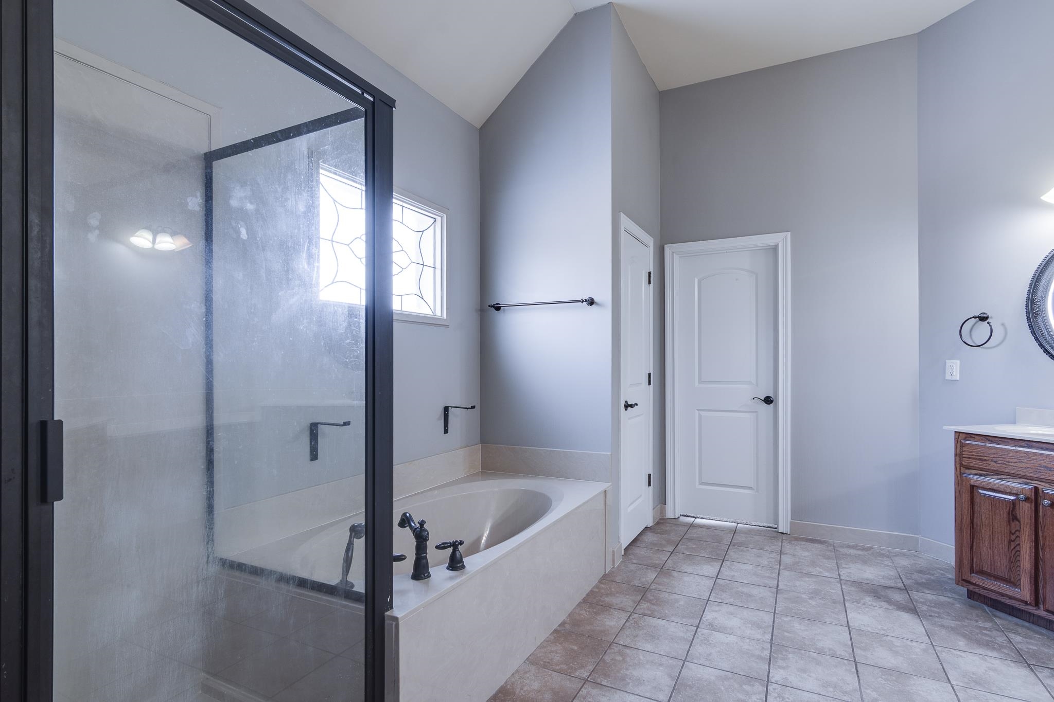 43 Tipton Rdg Cove Munford, TN 38058 - Photo 8 of 30 Bathroom with a garden tub, vanity, a shower stall, and light tile patterned floors