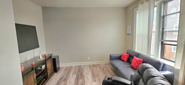 a bedroom with furniture and a flat screen tv