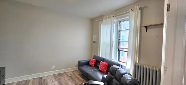 a bedroom with furniture and a window