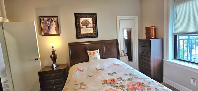 a bedroom with a bed and a window