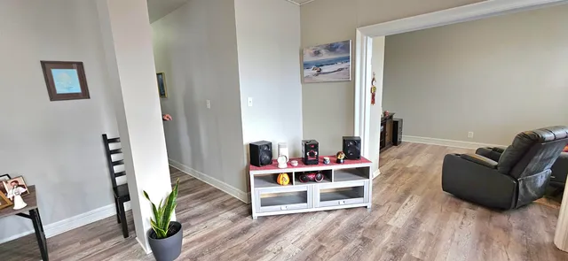 a living room with furniture and wooden floor