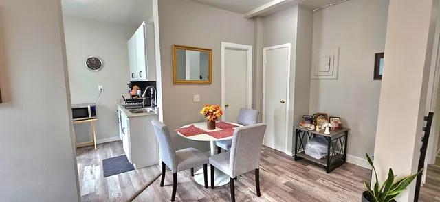 a dining room with furniture and wooden floor