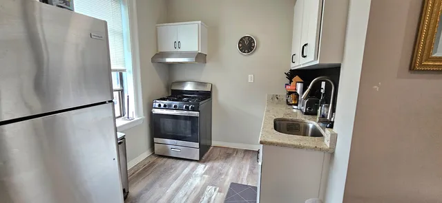 a kitchen with a refrigerator and a sink