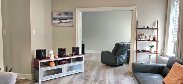 a living room with furniture and a book shelf