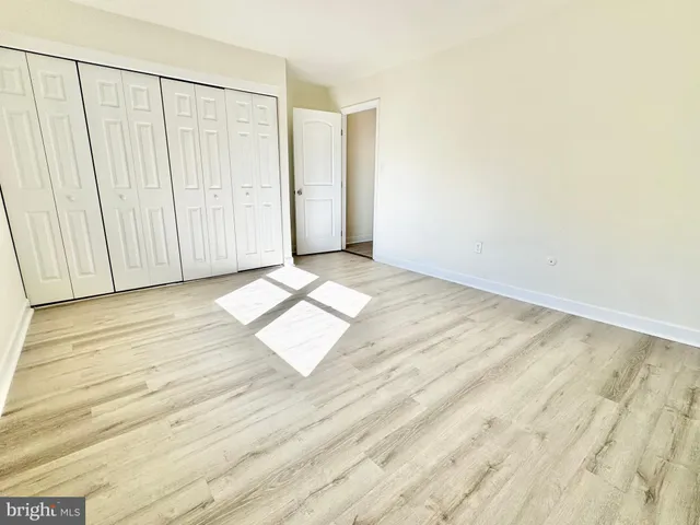 a view of wooden floor and windows in a room