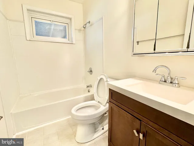a bathroom with a sink a toilet and bathtub