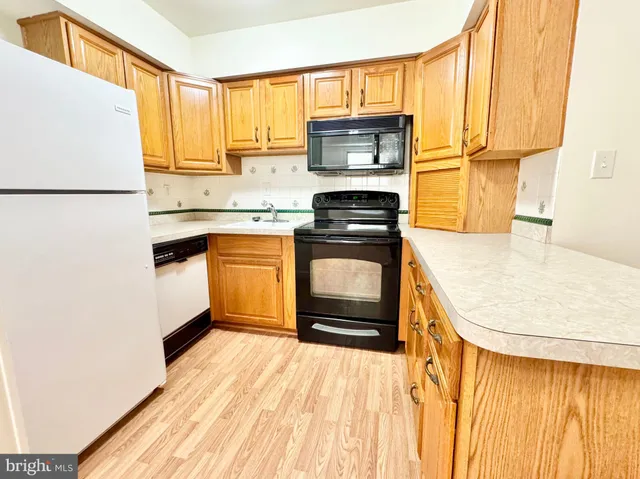 a kitchen with a stove a sink and a refrigerator