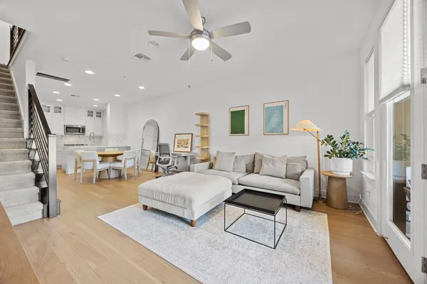 a living room with furniture and a chandelier